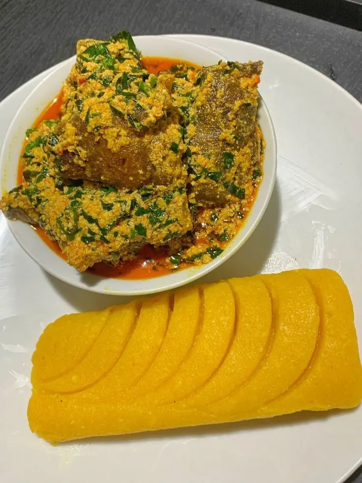 Efo riro vegetable soup served with sliced boiled yam