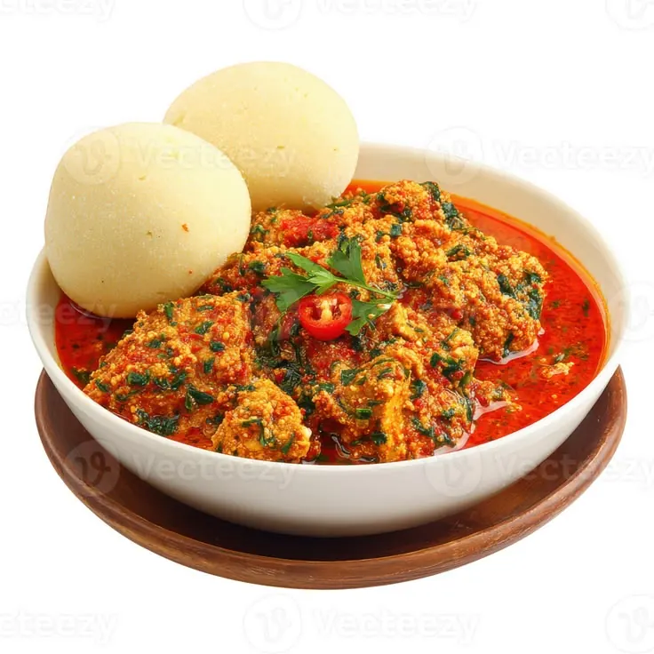 Egusi soup in a clay bowl beside two moulds of pounded yam