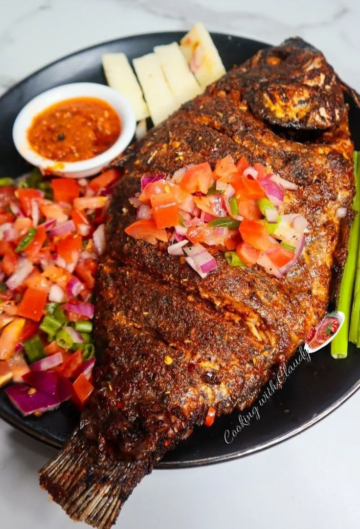 Whole grilled tilapia with pepper sauce and fried plantain