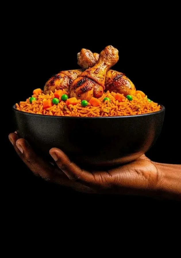 Two hands presenting a bowl of jollof rice topped with chicken